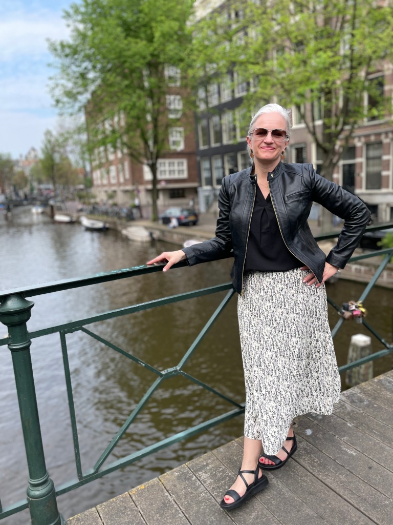 Heather standing on a bridge over a canal in Amsterdam, Netherlands Leading LCTE, Undergraduate Study Abroad